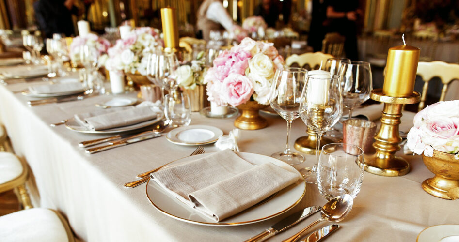 Shiny glassware and cutlery stand on the dinner table decorated