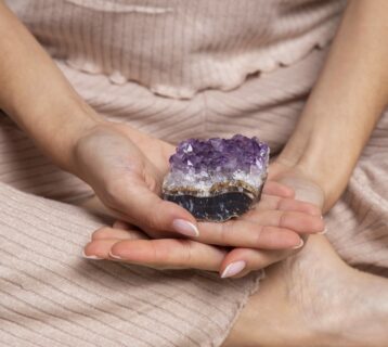 hands-holding-purple-crystal