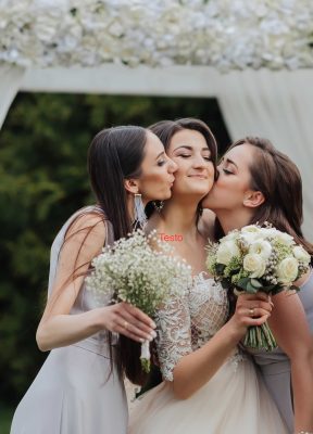brunette-bride-white-elegant-dress-her-friends-gray-dresses-pose-with-bouquets-wedding-portrait-nature-wedding-photo-light-colors