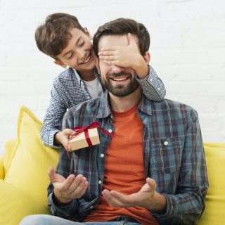 lovely-son-making-surprise-his-father